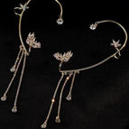 Star tassel earrings gold left ear